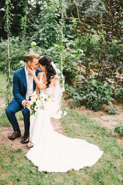 Niagara Wedding Planner | A Divine Affair | Sara and Daniel - Photo by Julia Park Photography. Ceremony and Reception at Kurtz Orchards Gracewood Estates. Ceremony under a chiffon and floral draped tree. Reception in a tent with live edge wooden harvest tables. 