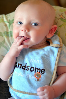 sammy baumer sucking his fingers while sporting a definition of handsome bib