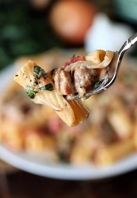 Fork Bite of Pasta in Creamy Sausage Sauce Image