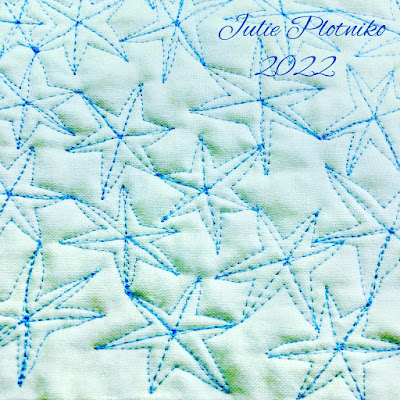 An all over pattern of blue six pointed stars