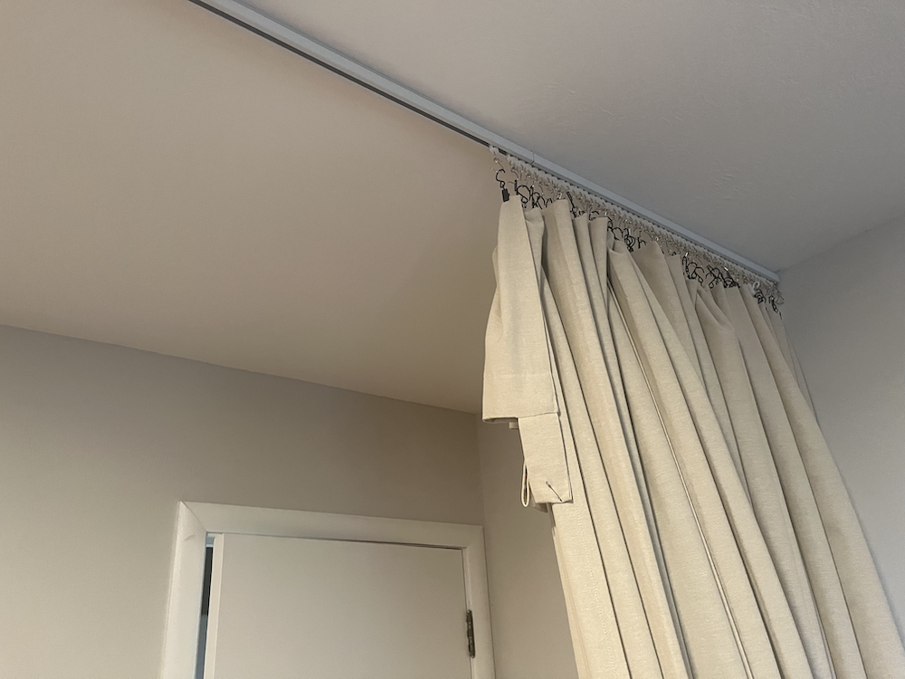 Photo of linen curtain on a ceiling curtain track