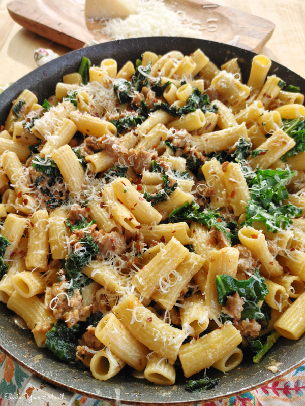 Spicy Sausage & Kale Rigatoni | A rustic, 30-minute pasta recipe of Italian sausage and kale with a simple but unbelievably delicious sauce made with pasta water, butter and parmesan cheese.