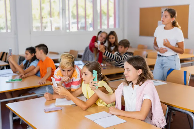 Children use smartphones in a classroom