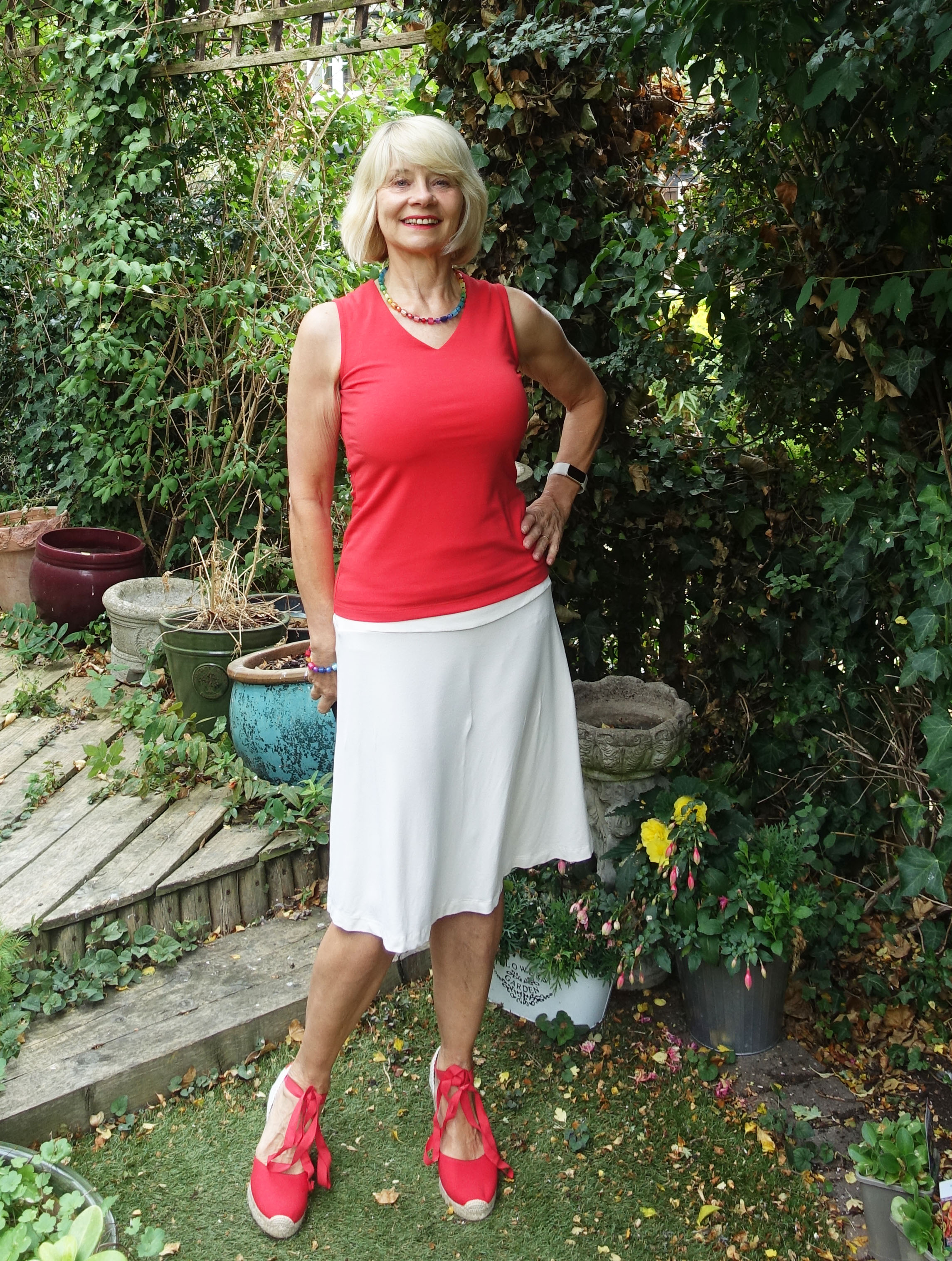 Gail Hanlon from Is This Mutton in red sleeveless top with cream skirt and red espadrilles