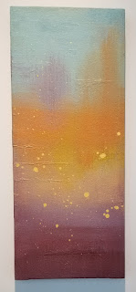 A rectangular abstract painting called “Emerging Brights” by Jeanette Beck, acrylic paint on canvas. It is a gradient of light blue, orange, and violet.