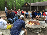 group sitting around a campfire