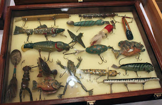 Grouping Of jitterbug Lures In Display Cases.