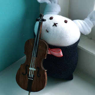sock bunny playing cello