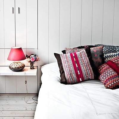 Colorful pillows in a neutral bedroom