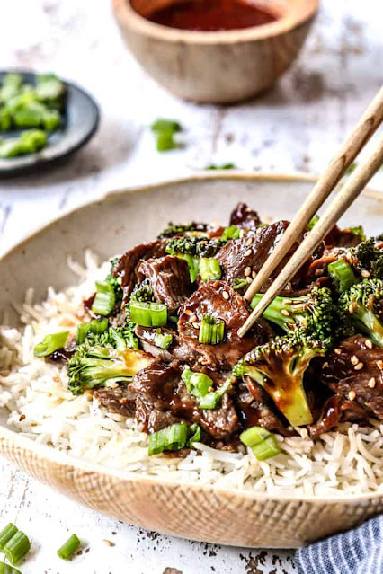 plate of rice topped with broccoli and beef