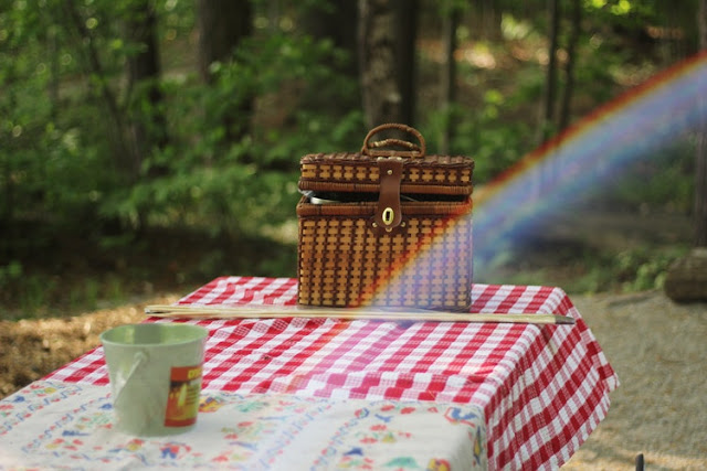 Picnic basket on a table with a picnic cloth