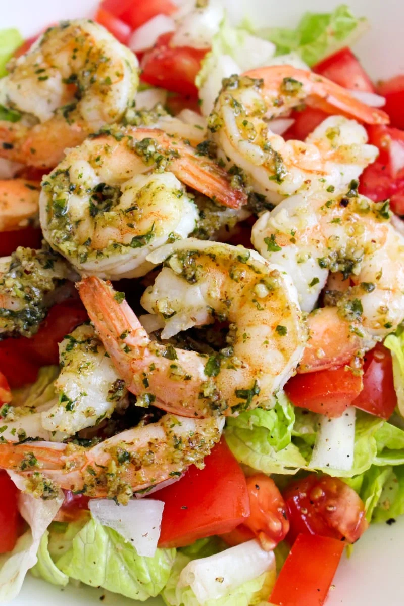 This 5 Minute Pesto Shrimp recipe is an easy, healthy, delicious way to prepare shrimp in just minutes! It's great served on a salad or as an accompaniment to steak. #shrimp #seafood