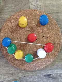 A happy face with pins and rubber band
