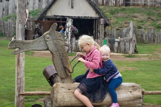 2 children on a wooden horse