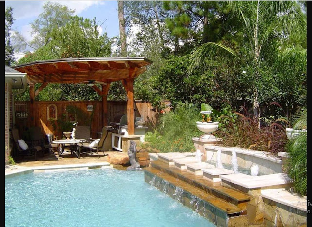 Pool Fountain Design Ideas with brown wooden pergola and waterfall also outdoor metal chairs and green garden plants also wooden fences