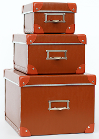 three orange storage boxes, stacked - small, medium and large