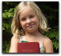 third grader holds her new Bible