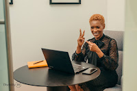 Black woman sitting in front of a laptop computer