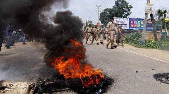 People block a road with a burning tyre during a protest over the gang rape (Photo: PTI)