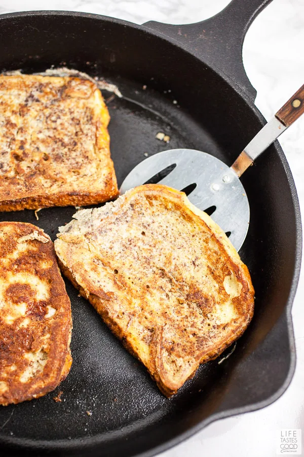 Cooking the french toast for Bananas Foster French Toast in a cast iron skillet