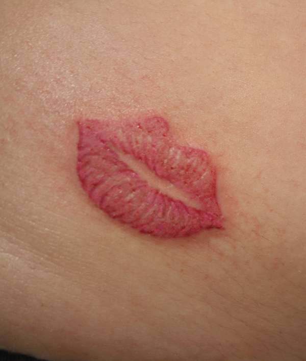 kissing lips tattoo. by making Lips Tattoo.