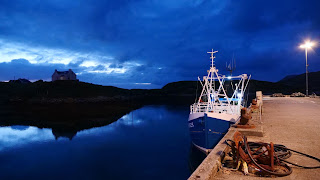 Fishing boat at a quay at night