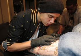 Justin Bieber giving Bang Bang a tattoo