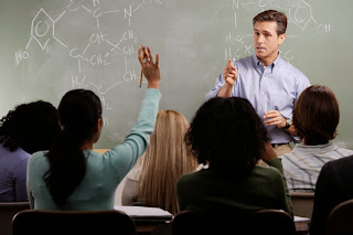 teacher fielding questions from his class