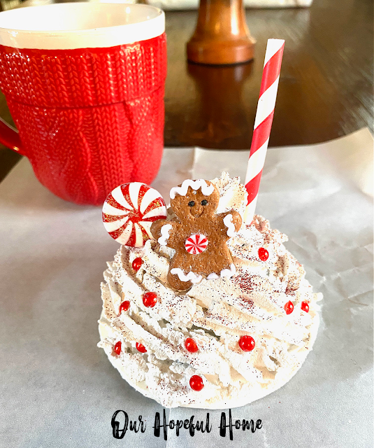 faux whipped cream mug topper with red and white decorations and gingerbread girl