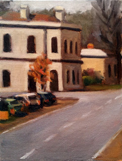 Oil painting of a street scene with a double-storey Victorian building on a corner and several parked cars in the middle ground.