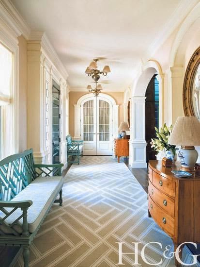 traditional beige hallway foyer with pops of turquoise