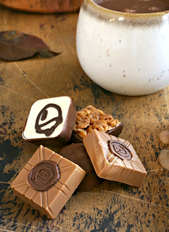 Recipe for pumpkin and chocolate chip snack cakes, topped with a cinnamon glaze and served with pumpkin and cinnamon hot cocoa.