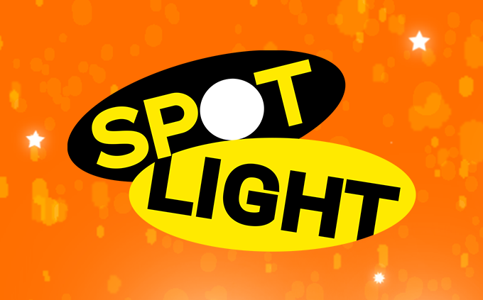 Orange With White Stars Shining Behind Yellow and Black Spotlight Logo Button To Watch Premieres