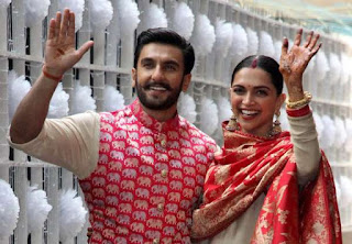 Newly married Bollywood actors Ranveer Singh and Deepika Padukone wave to the media