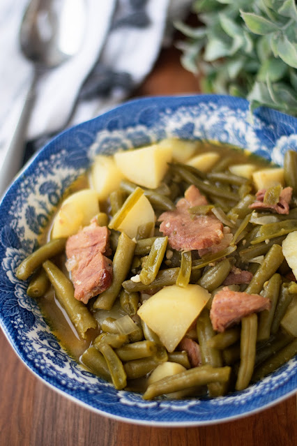 A bowl of the country style green beans and potatoes.