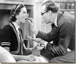 Henry Higgins puts marbles in Eliiza's mouth.  