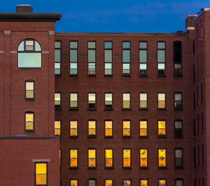 Sunset reflected in windows of old brick building in Portland, Maine USA June 2015 photo by Corey Templeton.