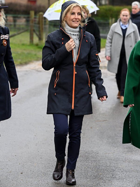 The Countess of Wessex wore a navy blue and orange softshell raincoat by Ilse Jacobsen. Denim jeans and leather boots