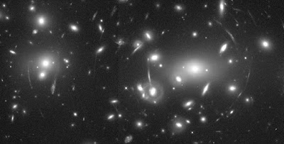 black and white photograph of lensed galaxies