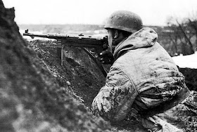 German paratrooper armed with an MP-40 submachine gun, in the trench on the Eastern Front; winter of 1942-1943..