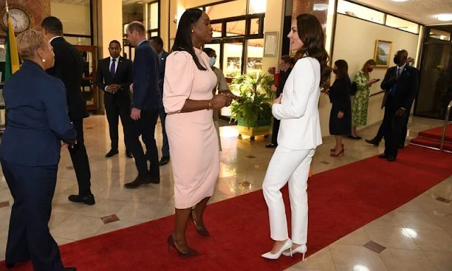 Kate Middleton wore a tangerine silk crepe de chine top by Ridley London, and white crape blazer by Alexander McQueen