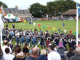Pipe band in arena, Nairn Highland Games