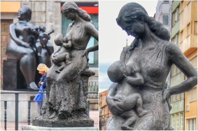 Escultura La Encarna con chiquilin Maternidad en el Campo de San Francisco de Oviedo – Al fondo, La maternidad de Botero en Oviedo