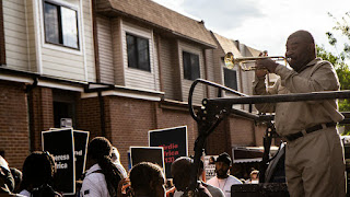 On May 13, 2021, trumpet player Kenneth Taylor played as protesters marched in honor of the lives of 11 people who died when the city bombed MOVE's West Philly house in 1985 KIMBERLY PAYNTER / WHYY Headshot_MalcolmBurnley