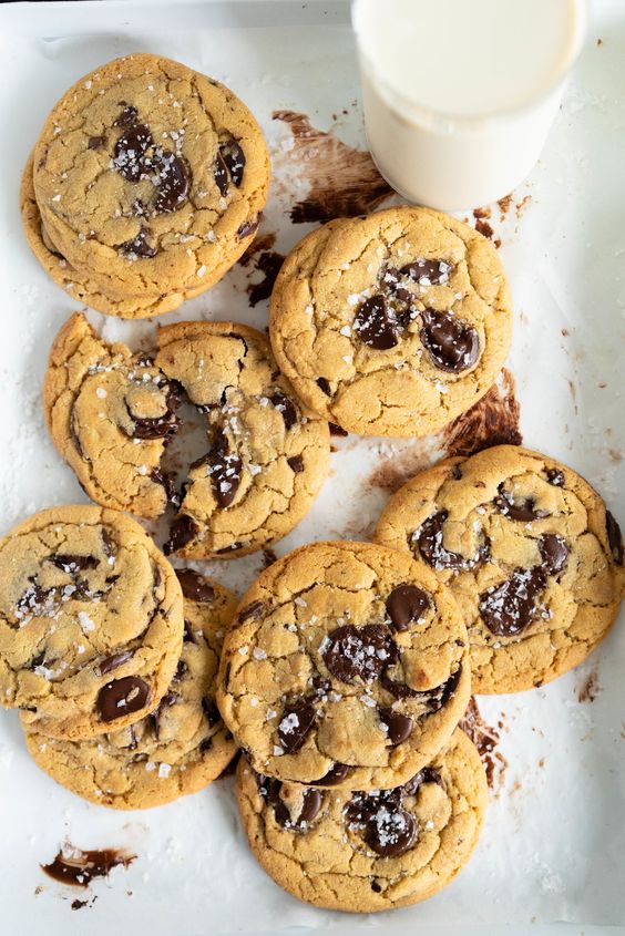 Olive Oil Chocolate Chip Cookies from The Cookie Book by Rebecca Firth. Huge, chewy chocolate chip cookies, with a unique fruitiness from the olive oil. These are a perfect twist on the classic chocolate chip cookie #chocolatechipcookie #oliveoilcookie #easycookierecipe