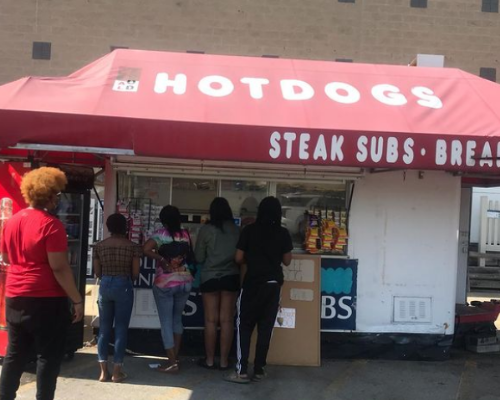 People try to reach the best hotdogs in front of the our store