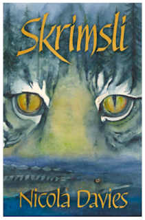 Small Book cover image with a silver tiger face with yellow eyes. The upper face merges into the background so it's fur becomes the silver white and grey snow covered trees of a forest. The lower third of the face merges into the river and a large scaly pike-like fish. The title at the top of the book, and the authors name at the bottom are written in a yellow gold font of upper and lower case.