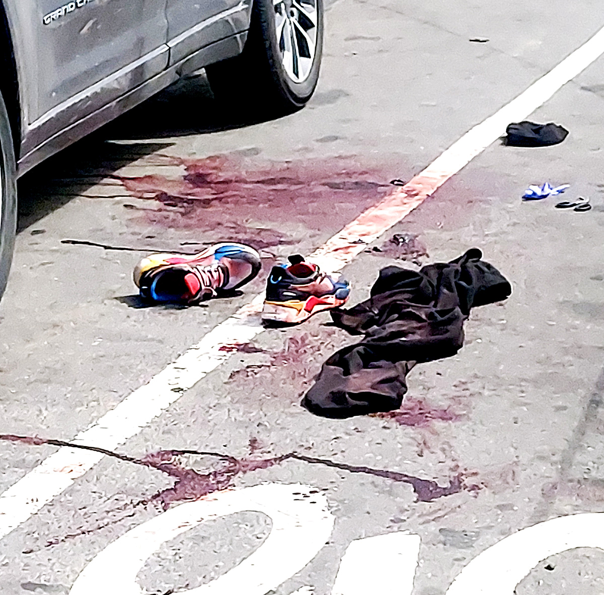 Dried blood surrounds a hat, hooded jacket and sneakers of gunshot victim Stefon Barnes, 29, of Manhattan who was shot and killed in the early morning hours of Easter Sunday.—Photo by David Greene