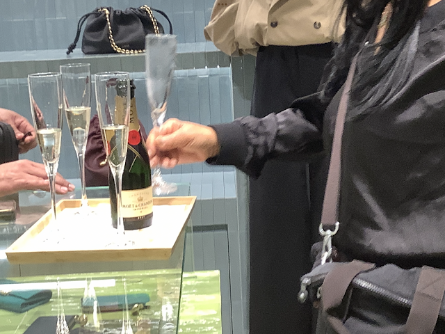 Store customers drinking Champagne