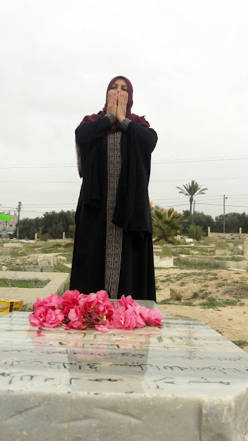 Mrs Amal El-Dora visiting Mohamed's grave at the old Bureij cemetery in Gaza